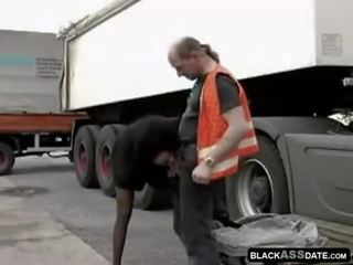 Black fancy woman riding on ripened truck driver outside